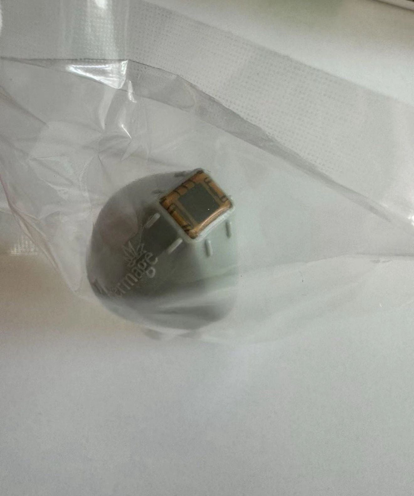 Angled view of Thermage CPT Eye Tip 0.25cm² – 450 Reps in sterile wrap, showing treatment surface and branding.
