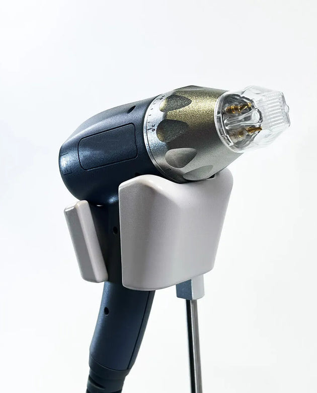 Medical device with a screen and handheld probe on a light gray background (PinOva Aesthetic)